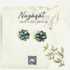 Oxidized silver floral earrings with blue petal-shaped stones and mirror accents by Nazāqat, displayed on a floral card