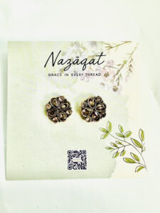 Floral oxidized silver earrings with antique gold and champagne mirror stones by Nazāqat, displayed on floral packaging card