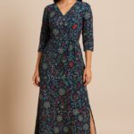 Woman wearing an indigo blue floral printed V-neck belted wrap dress with side slit by Nazāqat