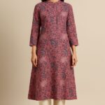 Woman wearing dusty rose pink floral A-line kurta with mandarin collar and ivory straight pants by Nazāqat
