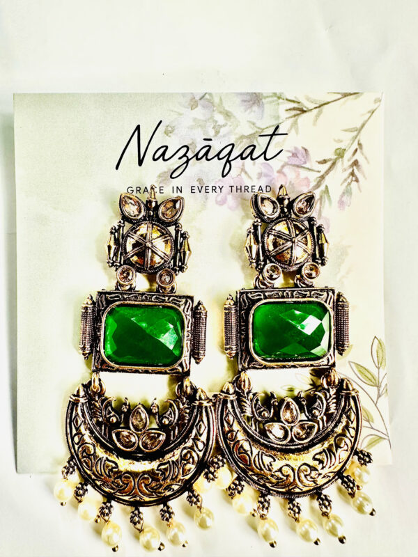 Handcrafted oxidized silver chandbali earrings with emerald green gemstone and pearl detailing by Nazāqat